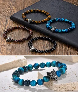 Macro detail of men's wolf head beaded bracelet with natural tiger eye gemstones