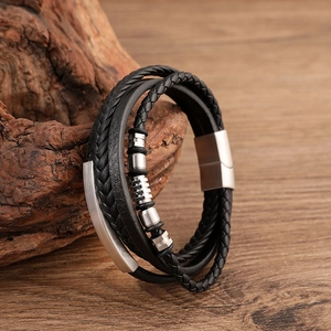 Close-up of multi-layer braided black leather bracelet with magnetic clasp and metal beads