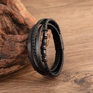 Men's multilayer black braided leather bracelet with matte magnetic clasp on wood