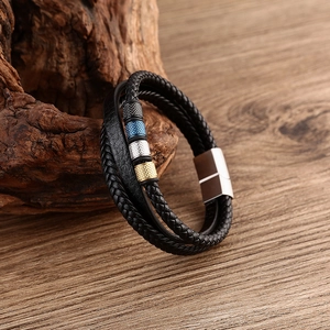 Detail view of multi-layer woven leather bracelet with colorful metal beads and magnetic clasp