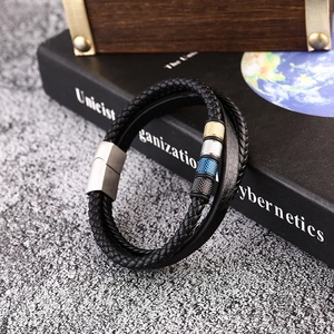Detail of men's leather bracelet showing woven cords and four textured metal beads