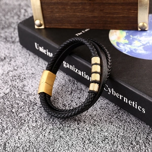 Detail of multi-layer black braided leather bracelet for men with golden magnetic clasp