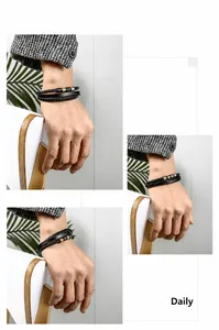 Detail of multi-layer black braided leather bracelets with gold silver and blue metal beads