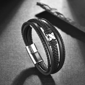 Men's multilayer braided leather bracelet with a metallic X-shape cross and magnetic clasp