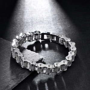 Detail showing the intricate knurled texture and industrial chain links of the steel bracelet