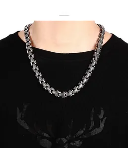 Detailed view of heavy vintage stainless steel dragon bone chain necklace on a male model