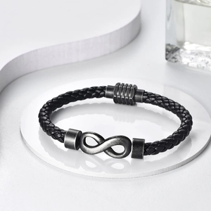 Retro black braided leather bracelet featuring a silver infinity charm and magnetic clasp