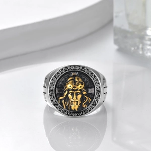 Detail of vintage silver titanium ring featuring gold Jesus relief and side cross icons