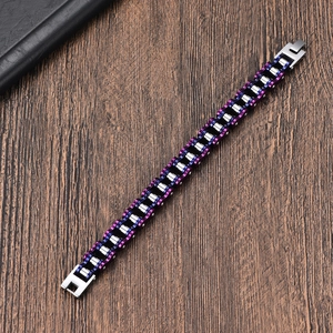 Close-up of bike chain bracelet with purple and blue electroplated links on wood