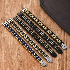 Detail of five punk style stainless steel bicycle chain bracelets on wooden table