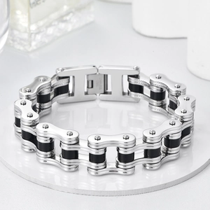 Macro view of industrial bike chain bracelet detail with stainless steel logo and folding clasp