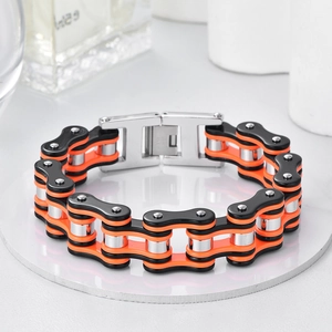 Detail of industrial bicycle chain bracelet with orange and black links and steel clasp