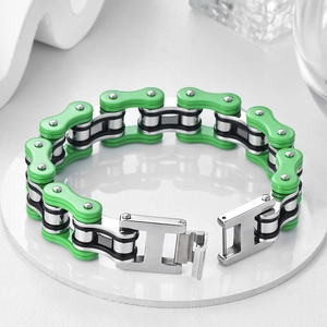 Detailed close-up of industrial bike chain bracelet with green accents and folding clasp