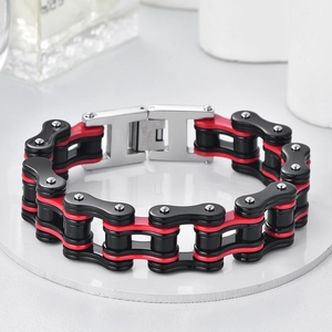 Macro detail of red and black bicycle chain bracelet showing stainless steel engraving