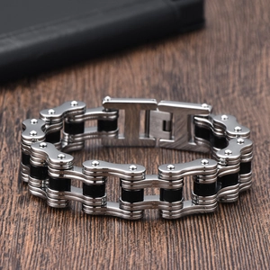Detailed close-up of industrial bicycle chain bracelet in silver and black stainless steel