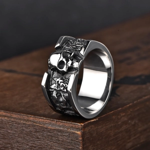 Hip hop style stainless steel skull ring with vintage relief on dark wood base