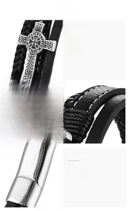 Détail macro du bracelet en cuir pour hommes avec fermoir magnétique en acier et croix gravée