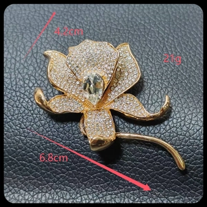 Detailed view of lily brooch with white rhinestones and crystal measuring 4.2cm x 6.8cm