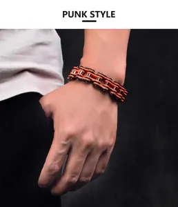 Detail of punk style bike chain bracelet in orange and black stainless steel finish