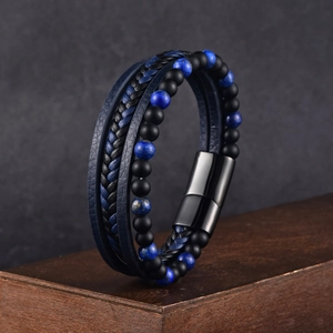 Macro shot of multi-layer blue braided leather bracelet with stone beads and magnetic clasp