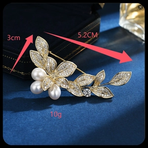 Detail of morning glory brooch with white pearls and gold plating showing 5.2cm size
