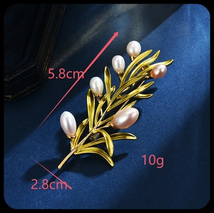 Detailed size view of gold pine branch brooch with freshwater pearls, 5.8cm x 2.8cm