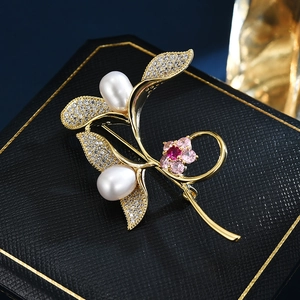Elegant gold sprout brooch with freshwater pearls and zircon leaves on black box