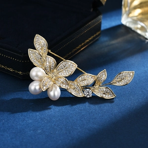 Elegant champagne gold morning glory brooch with white pearls and sparkling leaf crystals