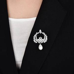 Elegant zircon pearl wreath brooch displayed on black suit lapel for high-end fashion styling