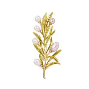Elegant gold pine branch brooch with five natural freshwater pearls on a white background