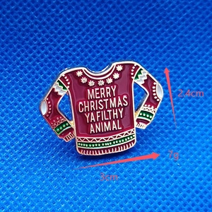 Christmas enamel brooch featuring red ugly sweater design and holiday quote on blue background