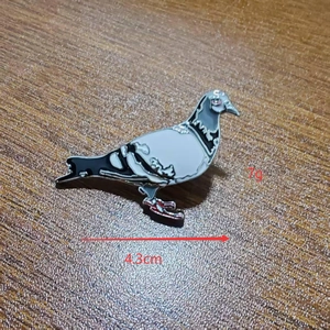 Detailed view of metal pigeon enamel lapel pin with 4.3cm length and 7g weight measurements