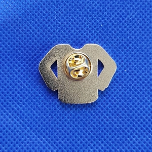 Detail showing the golden metal back of the Christmas sweater brooch with butterfly clutch