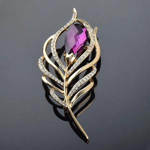 Détail de broche plume en cristal avec pierre violette et alliage plaqué or élégant