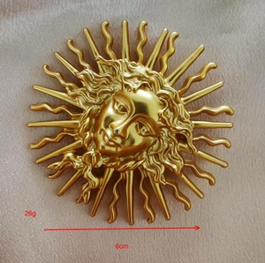 Detail of vintage sun goddess brooch with 6cm diameter and 26g weight specifications