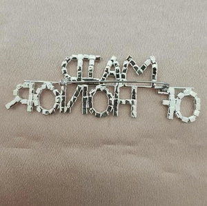 Silver tone J'ADIOR letter brooch with crystals showing the back clasp mechanism