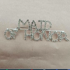 Detailed view of Maid of Honor silver brooch with sparkling rhinestones on pink satin