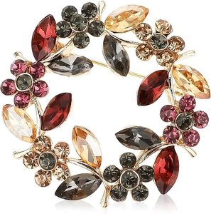 Detailed macro view of crystal flower brooch with colorful rhinestones on gold base