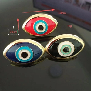 Detailed view of evil eye enamel jewelry pieces showing 3.8cm width and 2.6cm height size