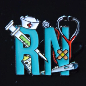 Macro shot of an enamel RN nurse brooch with medical syringe and stethoscope details
