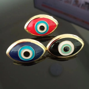 Detailed view of evil eye rings featuring colorful enamel inlay and gold plating