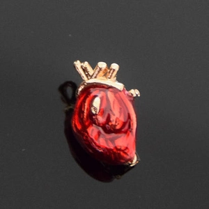 Anatomical heart brooch with red enamel finish and gold metal base for unique apparel styling