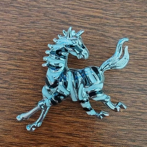 Vista dettagliata di un'elegante spilla a forma di zebra in argento con smalto