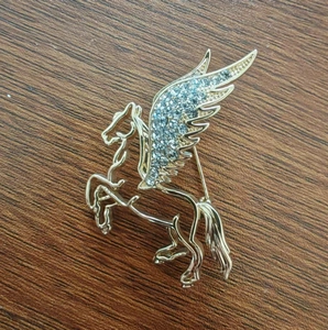 Golden Pegasus brooch for women with sparkling crystal wings and elegant metal design
