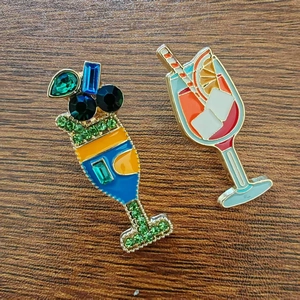Macro detail of jeweled summer drink brooches with rhinestones and colorful enamel