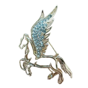 Elegant gold Pegasus brooch with light blue rhinestones on a white background