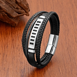 Men's multilayer braided leather bracelet with hollow stainless steel plate on wood