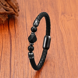 Men's black braided leather bracelet with tiger eye beads and magnetic clasp on wood