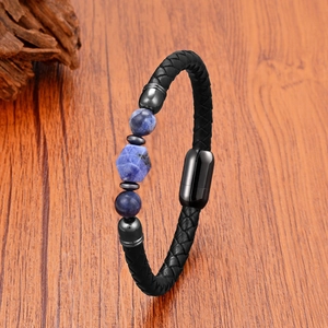 Mens black braided leather bracelet with blue tiger eye stones and magnetic clasp on wood