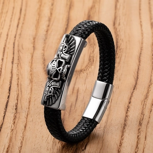 Detailed view of punk skull bracelet with braided leather and metallic wings buckle